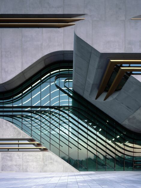 Curved, futuristic curtain wall façade of the Pierres Vives building in Montpellier, France.